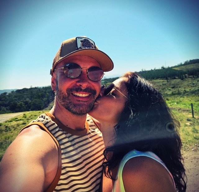 Juniper kissing Prayz on the cheek outdoors in South Africa